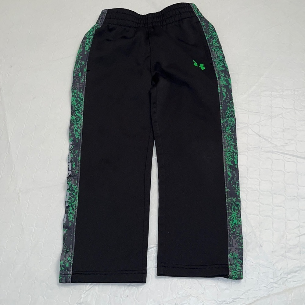 Under Armour black performance track pants with green logo detail and pockets